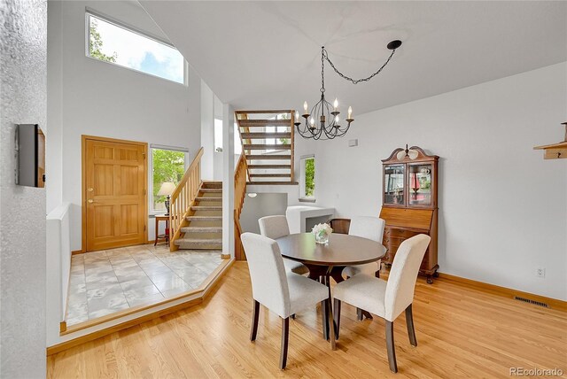 766 Chimney Creek Dr, Golden, CO 80401 - dining area with stairway, plenty of natural light, a chandelier, and wood finished floors
