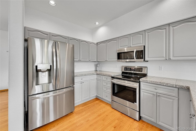 766 Chimney Creek Dr, Golden, CO 80401 - kitchen featuring stainless steel appliances, gray cabinets, tile counters, light wood-style flooring, and recessed lighting