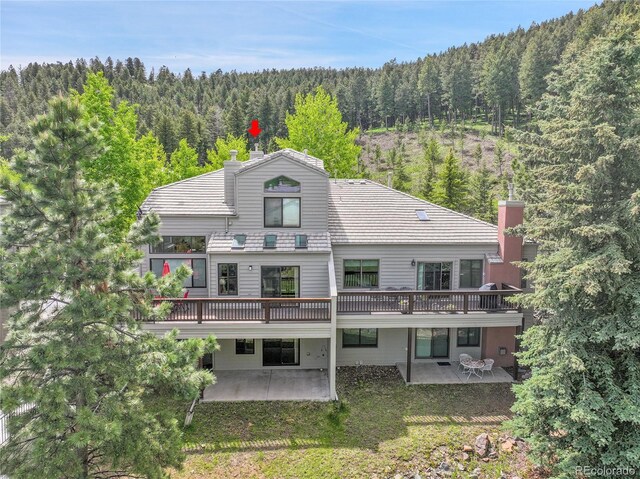 766 Chimney Creek Dr, Golden, CO 80401 - rear view of property featuring a forest view, a patio area, and a wooden deck