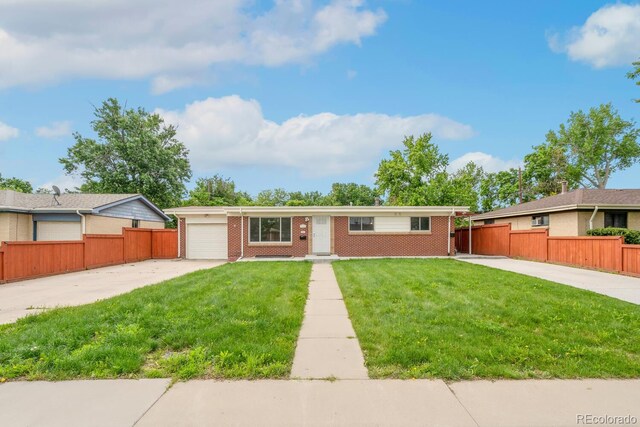 3216 Revere St, Aurora, CO 80011 - single story home with concrete driveway, brick siding, and an attached garage