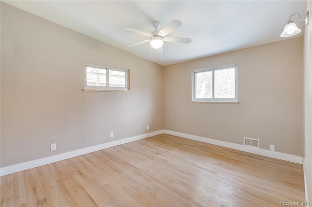 3216 Revere St, Aurora, CO 80011 - empty room with plenty of natural light, wood finished floors, a ceiling fan, baseboards, and vaulted ceiling