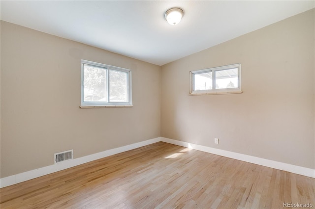 3216 Revere St, Aurora, CO 80011 - spare room featuring wood finished floors and baseboards