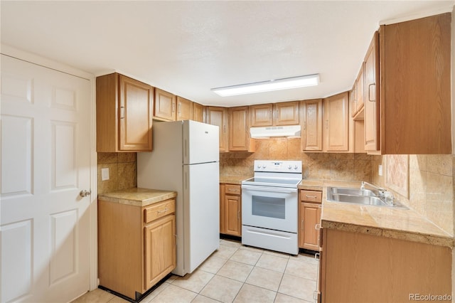 3216 Revere St, Aurora, CO 80011 - kitchen with white appliances, a sink, under cabinet range hood, and light countertops