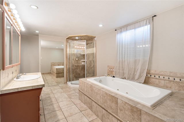 3216 Revere St, Aurora, CO 80011 - bathroom with vanity, a tub with jets, a shower stall, tile patterned flooring, and recessed lighting