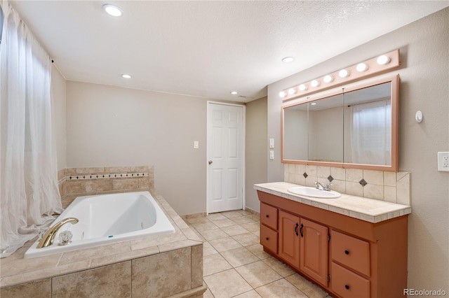 3216 Revere St, Aurora, CO 80011 - full bath with a whirlpool tub, vanity, decorative backsplash, recessed lighting, and tile patterned floors
