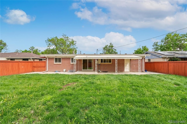 3216 Revere St, Aurora, CO 80011 - rear view of property with brick siding and a patio