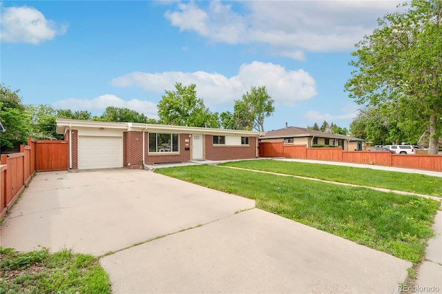 3216 Revere St, Aurora, CO 80011 - ranch-style home with brick siding, a garage, and driveway