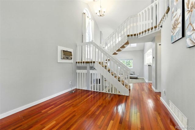 13651 W 65th Ave, Arvada, CO 80004 - foyer featuring hardwood / wood-style floors, stairs, a chandelier, and a towering ceiling