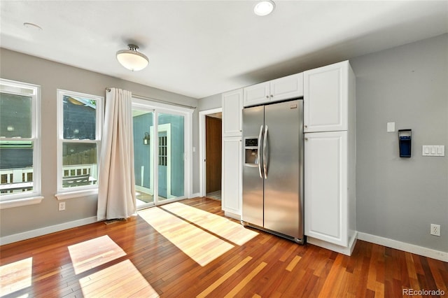 13651 W 65th Ave, Arvada, CO 80004 - kitchen featuring stainless steel refrigerator with ice dispenser, hardwood / wood-style flooring, and white cabinets