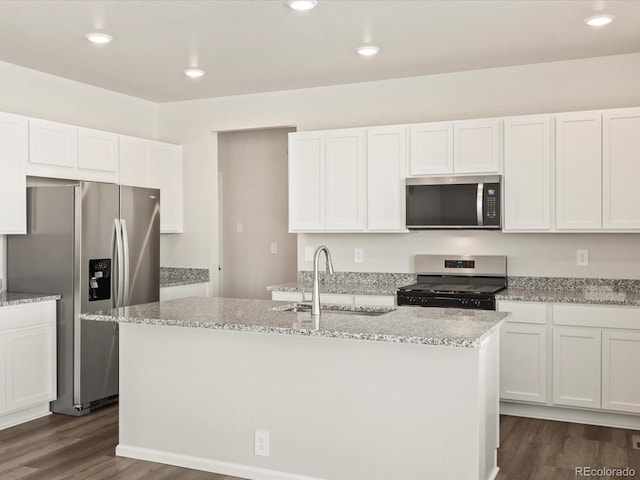 kitchen with stainless steel appliances, dark wood-style flooring, a sink, and white cabinetry