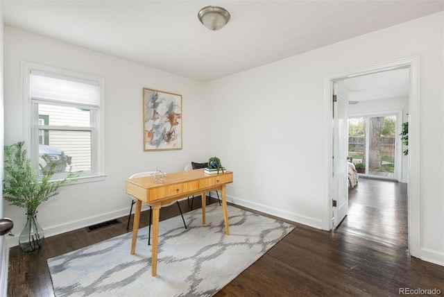 office with visible vents, baseboards, and dark wood-style flooring