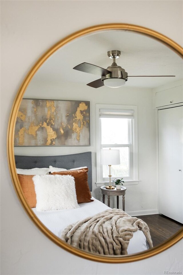sitting room with baseboards, a ceiling fan, and wood finished floors