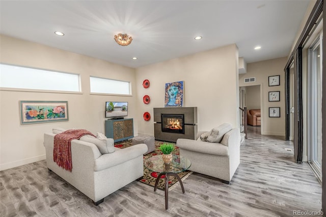 6761 Alan Dr, Denver, CO 80221 - living area featuring light wood-type flooring, recessed lighting, and a glass covered fireplace