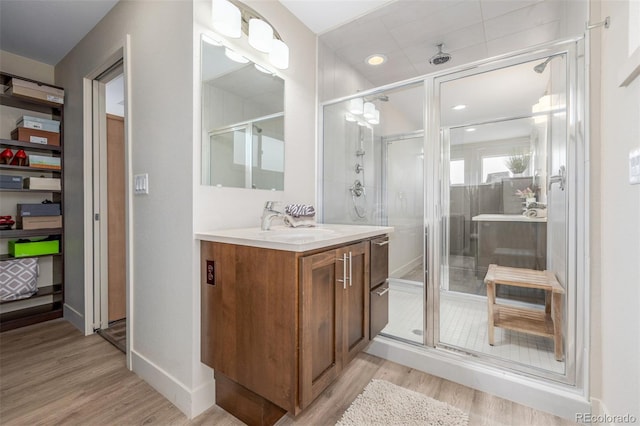 6761 Alan Dr, Denver, CO 80221 - full bathroom with vanity, wood finished floors, a stall shower, and recessed lighting