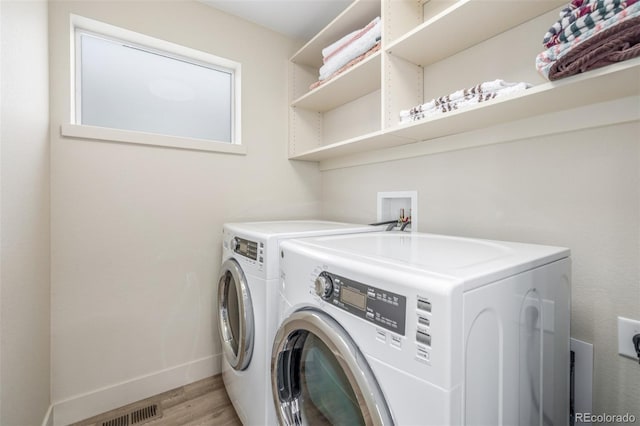 6761 Alan Dr, Denver, CO 80221 - laundry area with independent washer and dryer and light wood finished floors