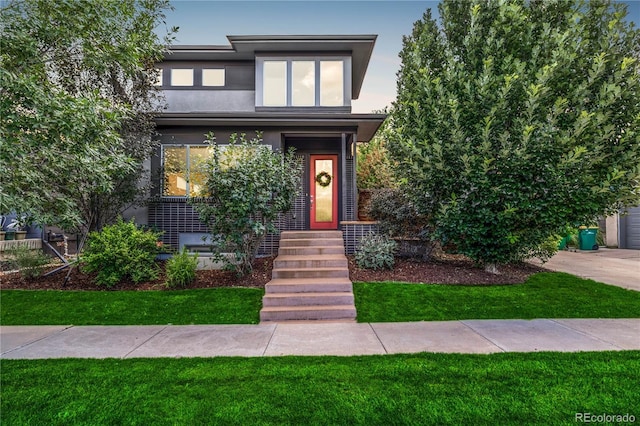 6761 Alan Dr, Denver, CO 80221 - view of front of house with stucco siding and a front lawn