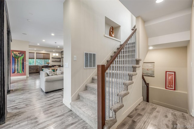 6761 Alan Dr, Denver, CO 80221 - stairway with wood finished floors and recessed lighting