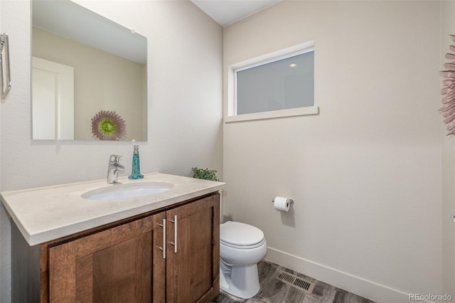 6761 Alan Dr, Denver, CO 80221 - half bathroom with vanity and toilet
