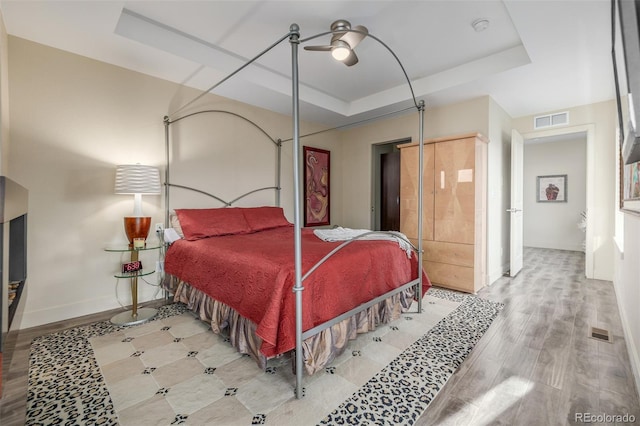 6761 Alan Dr, Denver, CO 80221 - bedroom with a raised ceiling, wood finished floors, and ceiling fan