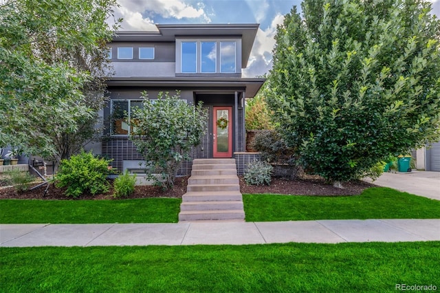 6761 Alan Dr, Denver, CO 80221 - view of front of property featuring stucco siding and a front lawn
