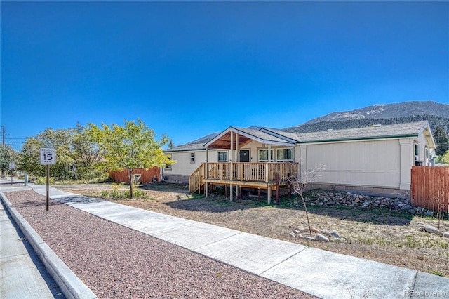 view of front of property featuring a garage and a deck with mountain view