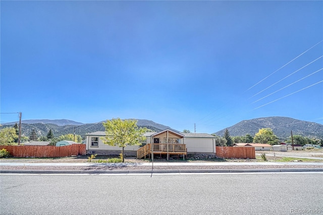 view of front of home featuring a deck with mountain view