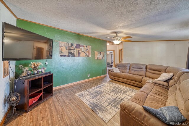 205 Sabeta Ave, Poncha Springs, CO 81242 - living room with a textured ceiling, wood finished floors, a ceiling fan, baseboards, and ornamental molding