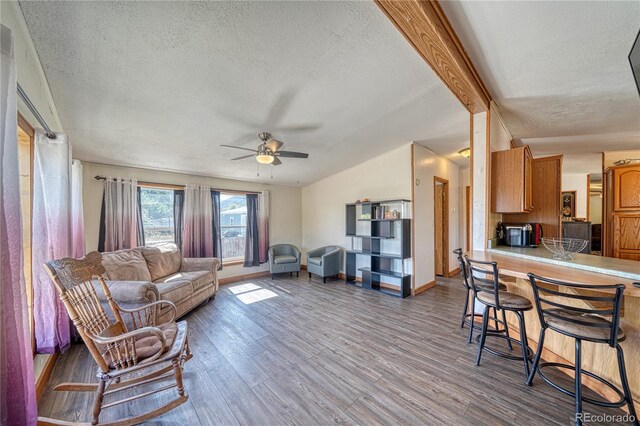 205 Sabeta Ave, Poncha Springs, CO 81242 - living room with a textured ceiling, ceiling fan, wood finished floors, and baseboards