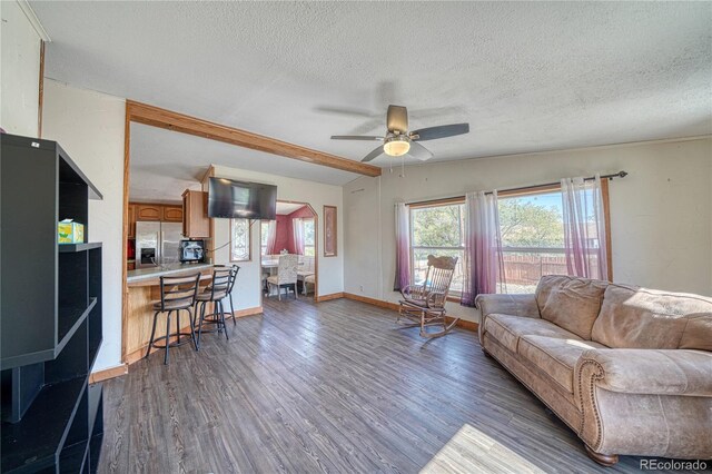 205 Sabeta Ave, Poncha Springs, CO 81242 - living area with a textured ceiling, a ceiling fan, wood finished floors, and baseboards