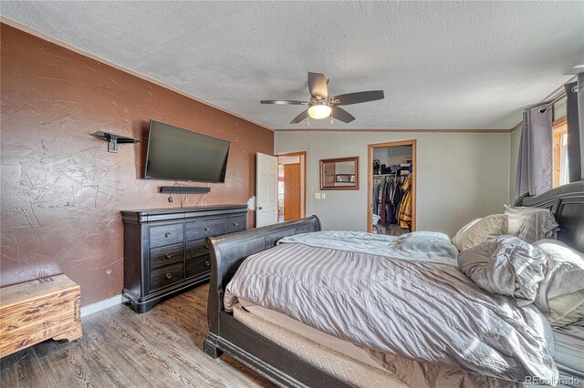 205 Sabeta Ave, Poncha Springs, CO 81242 - bedroom with wood finished floors, a textured ceiling, a walk in closet, crown molding, and a ceiling fan