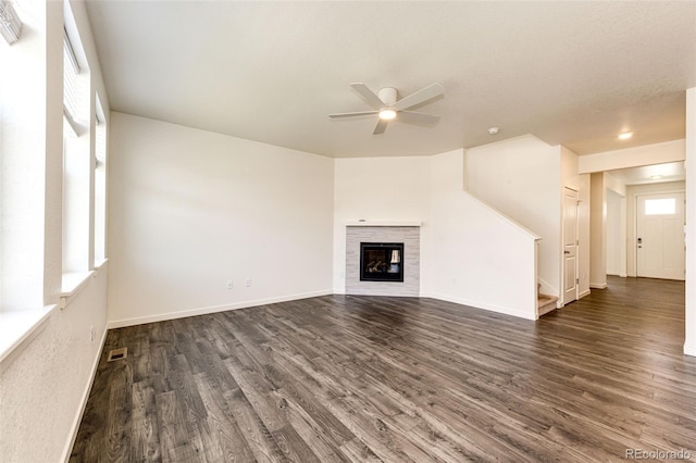 13376 Willow St, Thornton, CO 80602 - unfurnished living room featuring dark wood finished floors, a ceiling fan, stairway, and a glass covered fireplace