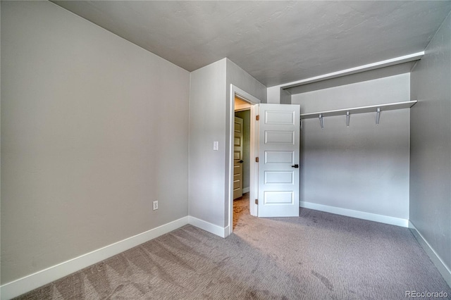 unfurnished bedroom with a closet and carpet