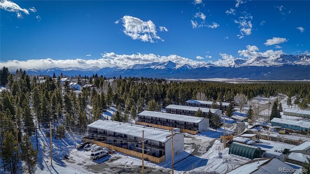 snowy aerial view with a mountain view