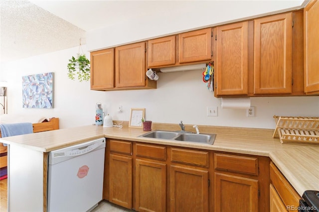 kitchen featuring white dishwasher, sink, a textured ceiling, and kitchen peninsula