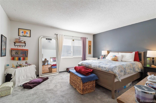 bedroom with a textured ceiling and carpet flooring