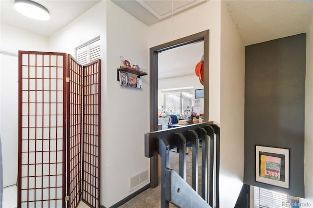 hallway featuring carpet flooring