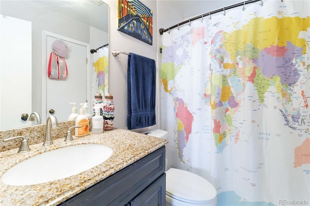 bathroom featuring toilet and vanity