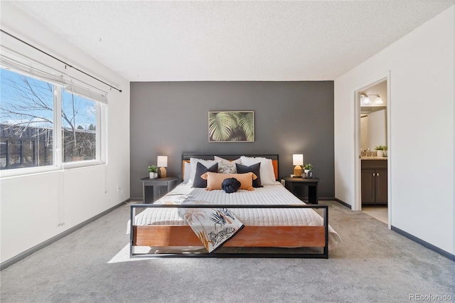 bedroom featuring a textured ceiling, carpet flooring, connected bathroom, and baseboards