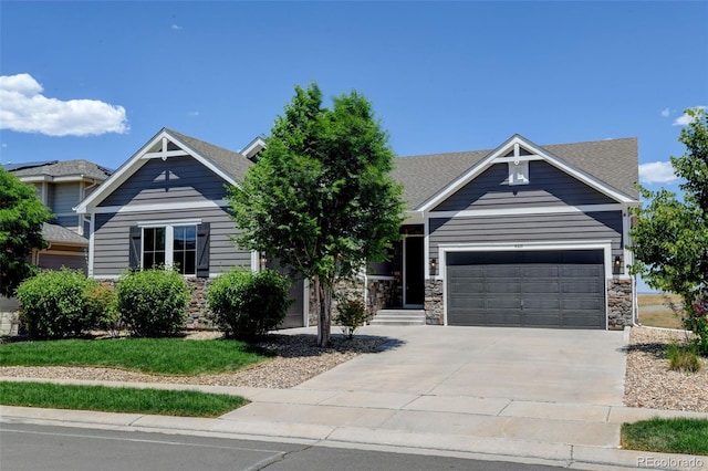 4011 W 149th Ave, Broomfield, CO 80023 - craftsman-style home featuring concrete driveway, an attached garage, roof with shingles, and stone siding