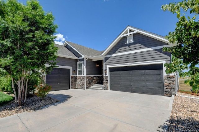 4011 W 149th Ave, Broomfield, CO 80023 - view of front of home featuring concrete driveway, stone siding, a garage, and roof with shingles
