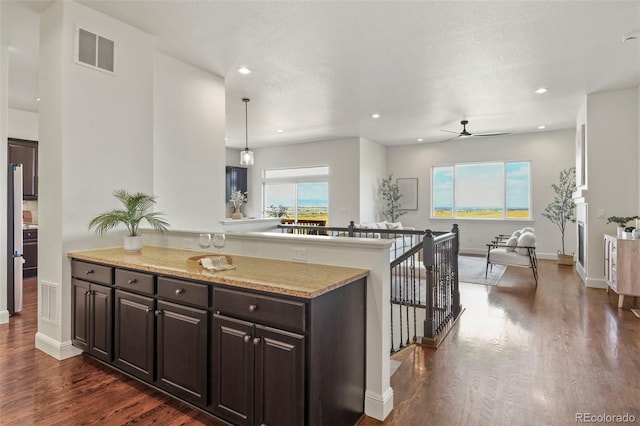 4011 W 149th Ave, Broomfield, CO 80023 - kitchen featuring dark wood-style flooring, ceiling fan, dark brown cabinets, recessed lighting, and light stone countertops