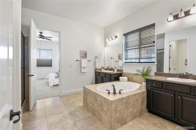 4011 W 149th Ave, Broomfield, CO 80023 - ensuite bathroom featuring a bath, two vanities, tile patterned floors, and a ceiling fan