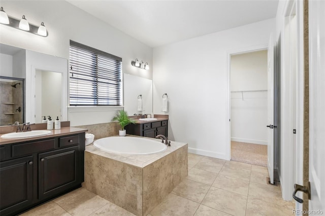 4011 W 149th Ave, Broomfield, CO 80023 - full bathroom featuring tile patterned floors, a bath, two vanities, a shower, and a spacious closet