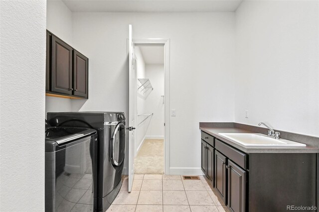 4011 W 149th Ave, Broomfield, CO 80023 - laundry room featuring cabinet space, independent washer and dryer, and light tile patterned floors