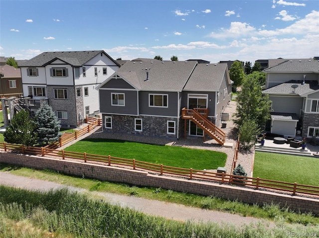 4011 W 149th Ave, Broomfield, CO 80023 - back of house with stairway, a residential view, and a fenced backyard