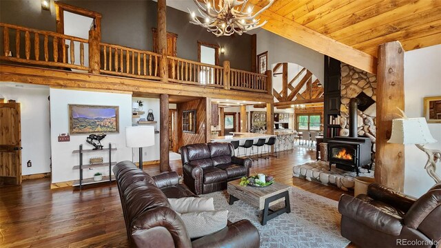 700 Cottage Grove Rd, Alma, CO 80420 - living room with hardwood / wood-style flooring, a chandelier, high vaulted ceiling, wooden ceiling, and arched walkways