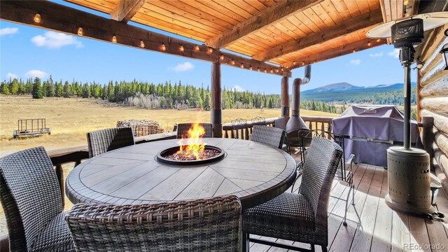 700 Cottage Grove Rd, Alma, CO 80420 - wooden terrace with a fire pit, outdoor dining area, a mountain view, and a rural view