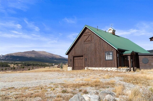700 Cottage Grove Rd, Alma, CO 80420 - view of side of home featuring a mountain view, a detached garage, and metal roof