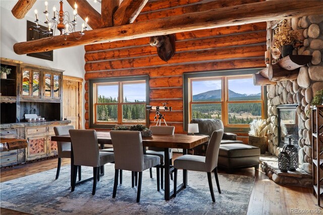 700 Cottage Grove Rd, Alma, CO 80420 - dining area with hardwood / wood-style flooring, beamed ceiling, log walls, a chandelier, and a mountain view
