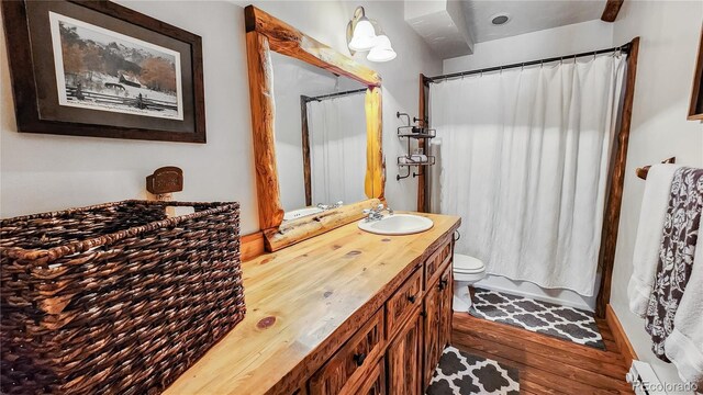 700 Cottage Grove Rd, Alma, CO 80420 - full bathroom featuring vanity, toilet, a shower with shower curtain, and wood finished floors